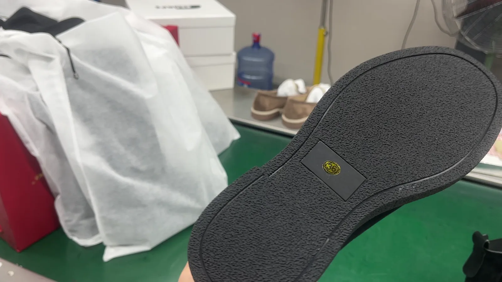 Close-up of a rubber outsole on a leather Chelsea boot during final inspection