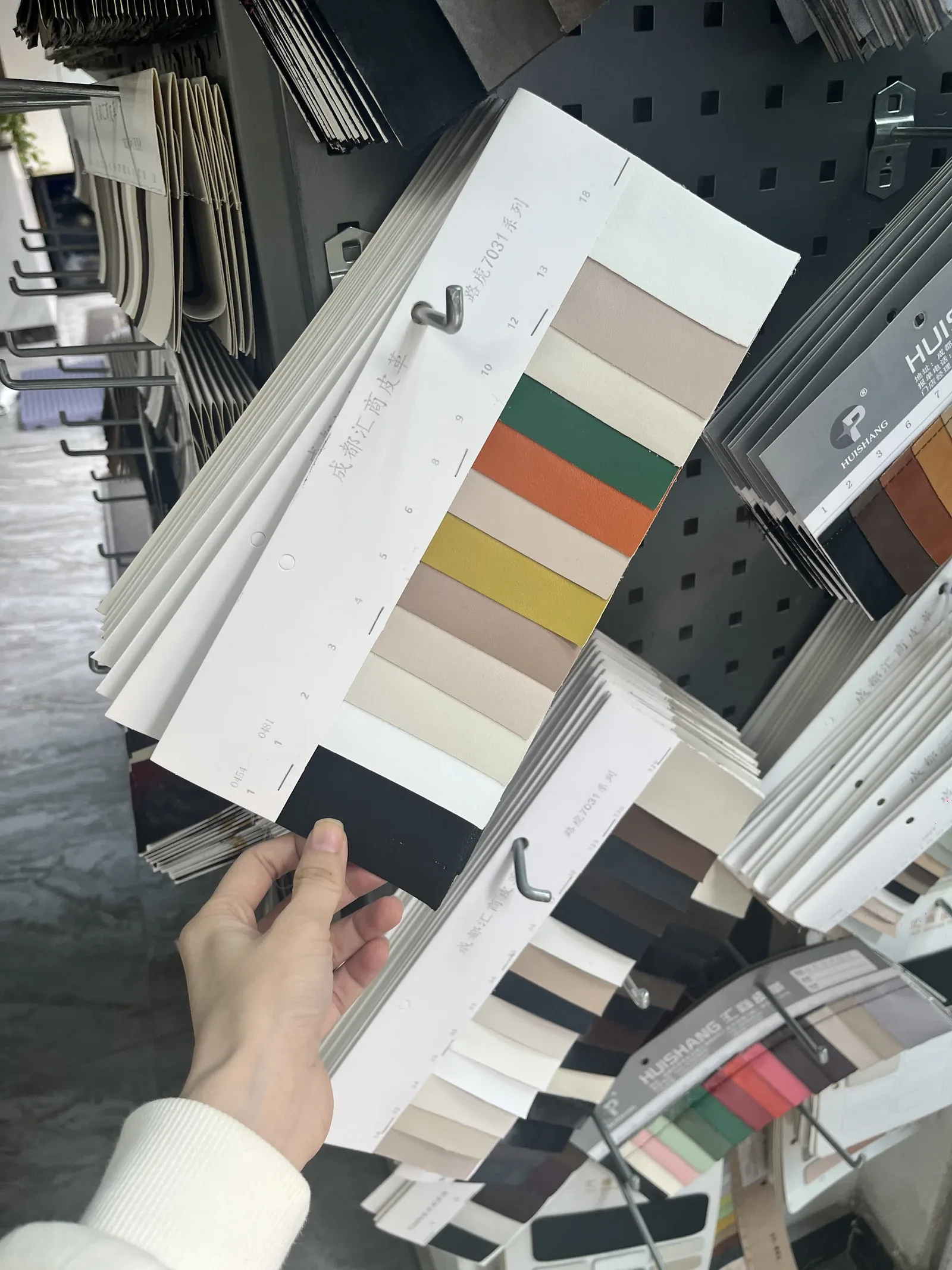 Assorted leather color swatch cards — the upper materials that EU REACH chemical testing screens