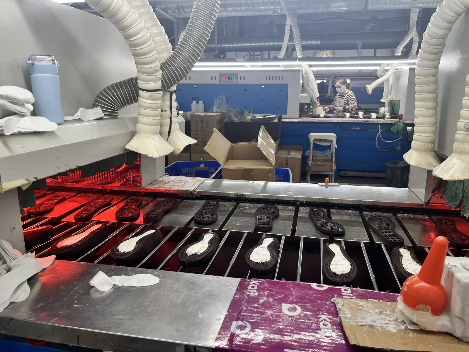 Semi-finished shoes moving along the production line during a first production run
